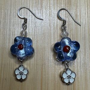 Blue flower glass bead earrings metal flower dangle and stainless steel hooks.